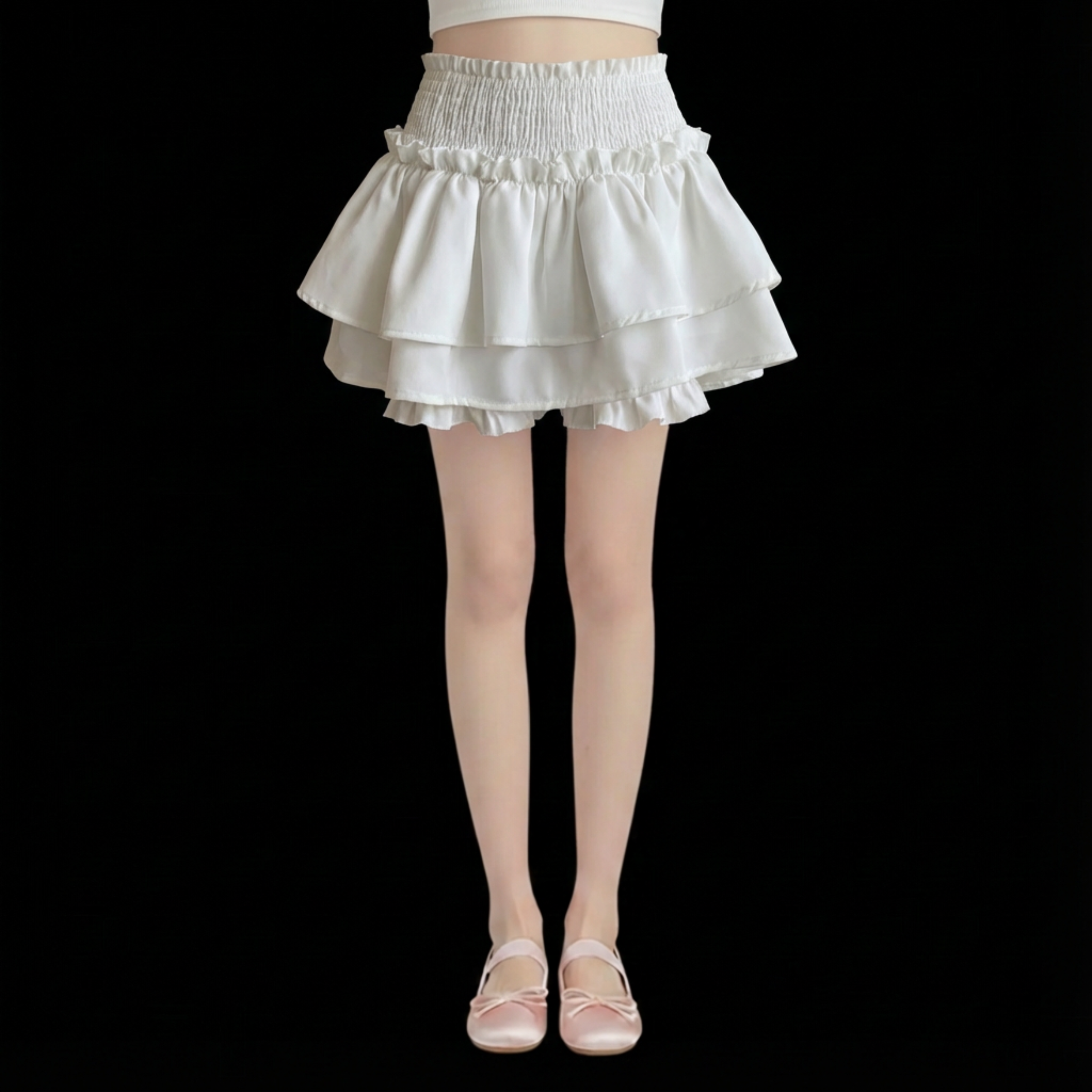 White tiered skirt worn by a person on a black background