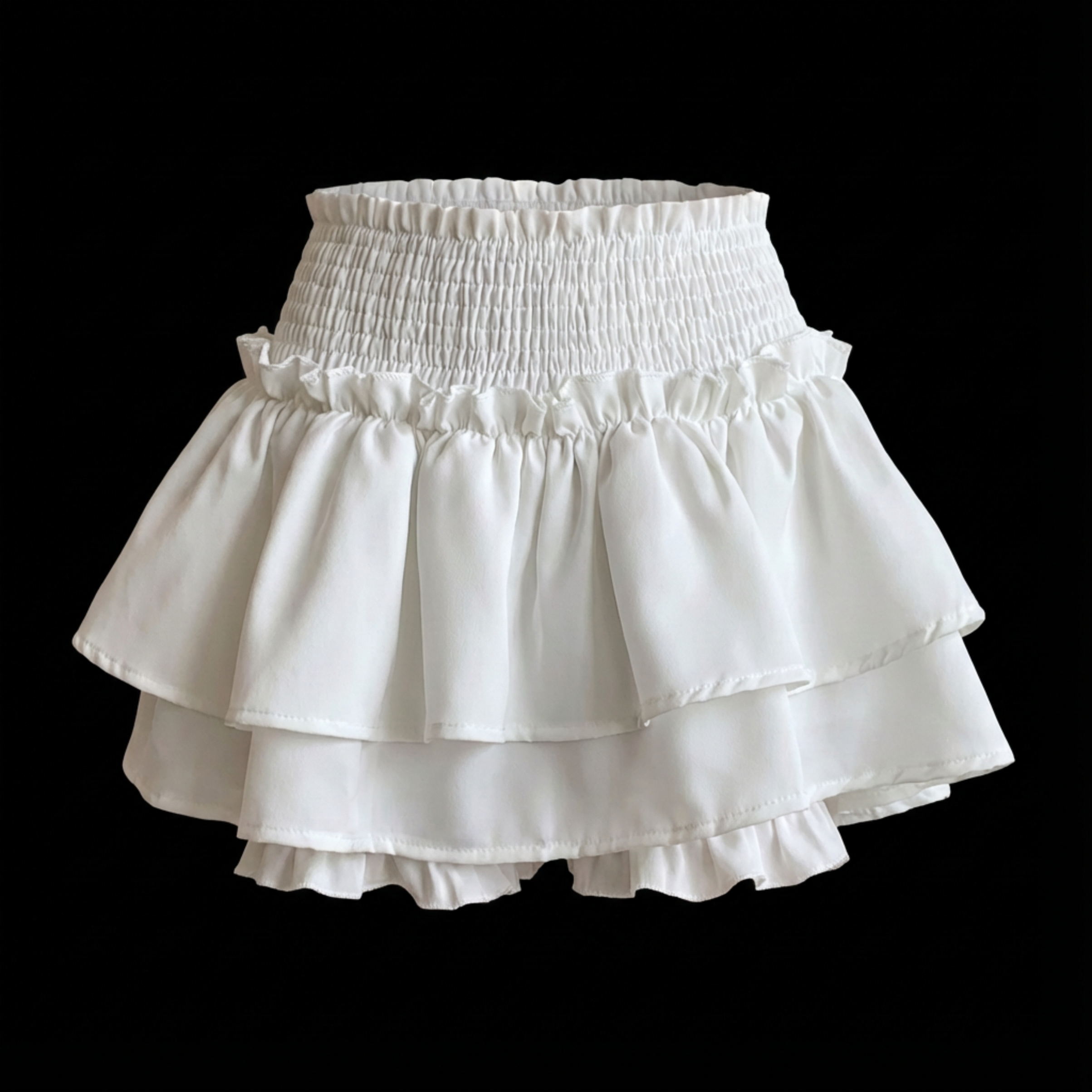 White tiered skirt on a black background